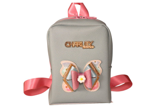 Handmade light blue toddler backpack with pink straps and butterfly bow accent